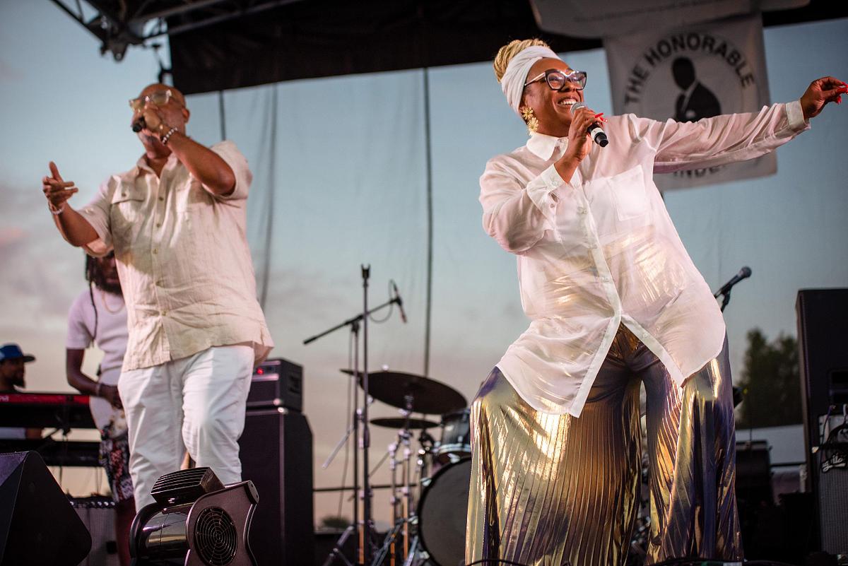 Live performance photography capturing Kindred the Family Soul on stage during a Philadelphia community celebration, highlighting musical artistry, audience energy, and cultural connection.