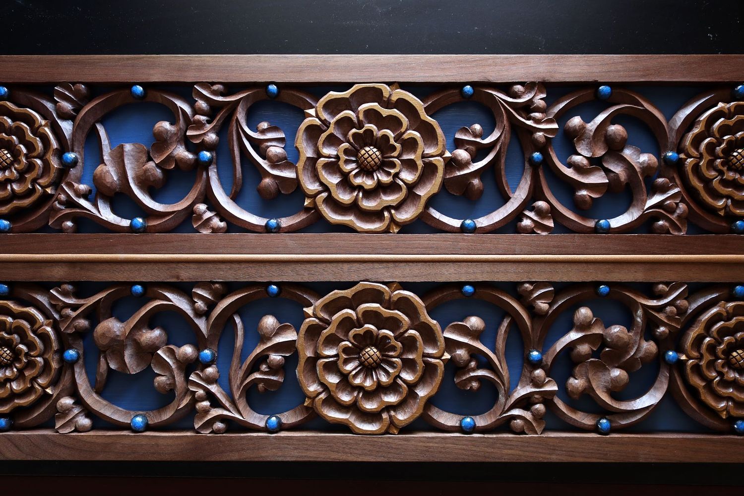 hand-carved rose and vine panel with liturgical blue background