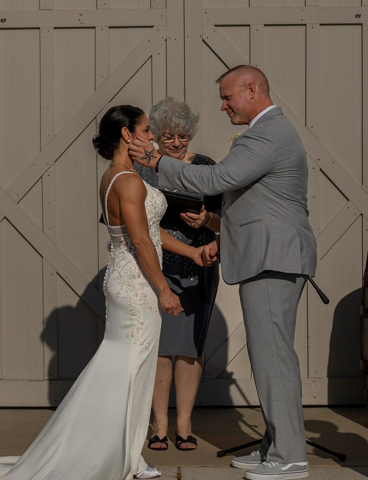 groom gently holding brides face in his hands after ceremony