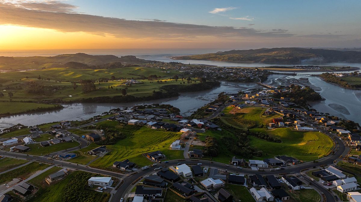 Twilight drone photography of Rangitahi Peninsula with sunset views of Mt Karioi by Flax Cove Studio.
