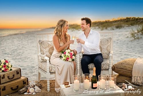 Couple toast with champagne at a boho-chic beach picnic in North Central Florida by Legacy of Love Photography.