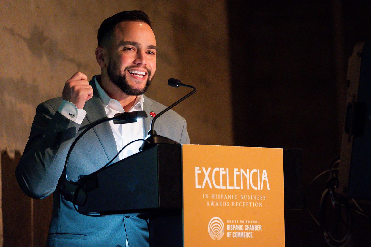 Corporate event photography capturing a keynote speaker delivering a confident and engaging address at the Excelencia Hispanic Business Awards in Philadelphia, emphasizing leadership, presence, and authentic connection.