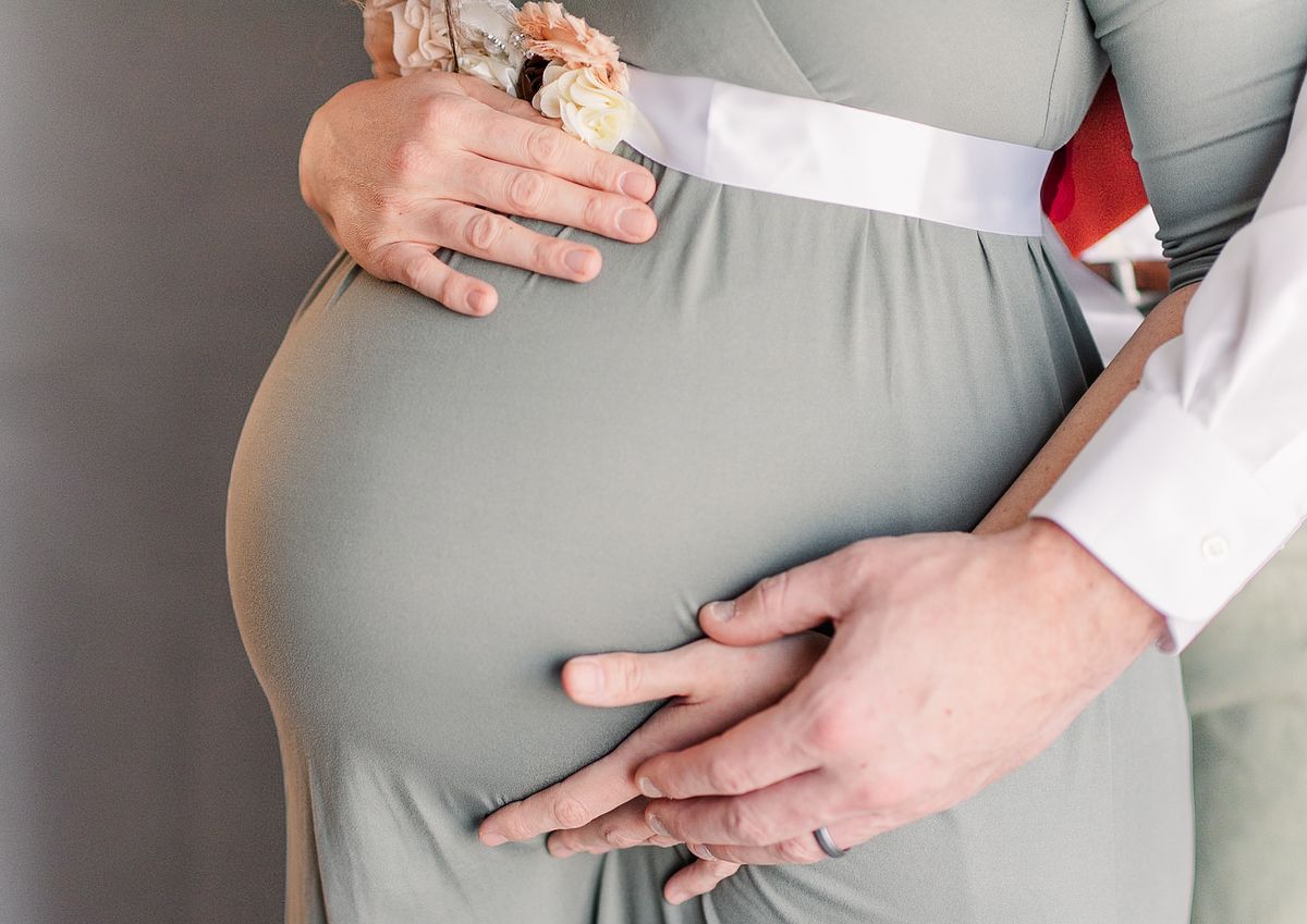 husband hugging wife with hands under and above her pregnant belly, faceless, session with Cranberry Township, PA photographer