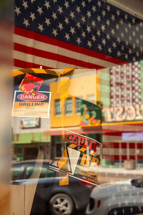 Store window display in Scottsbluff, Nebraska featuring a prominent American flag for Father's Day